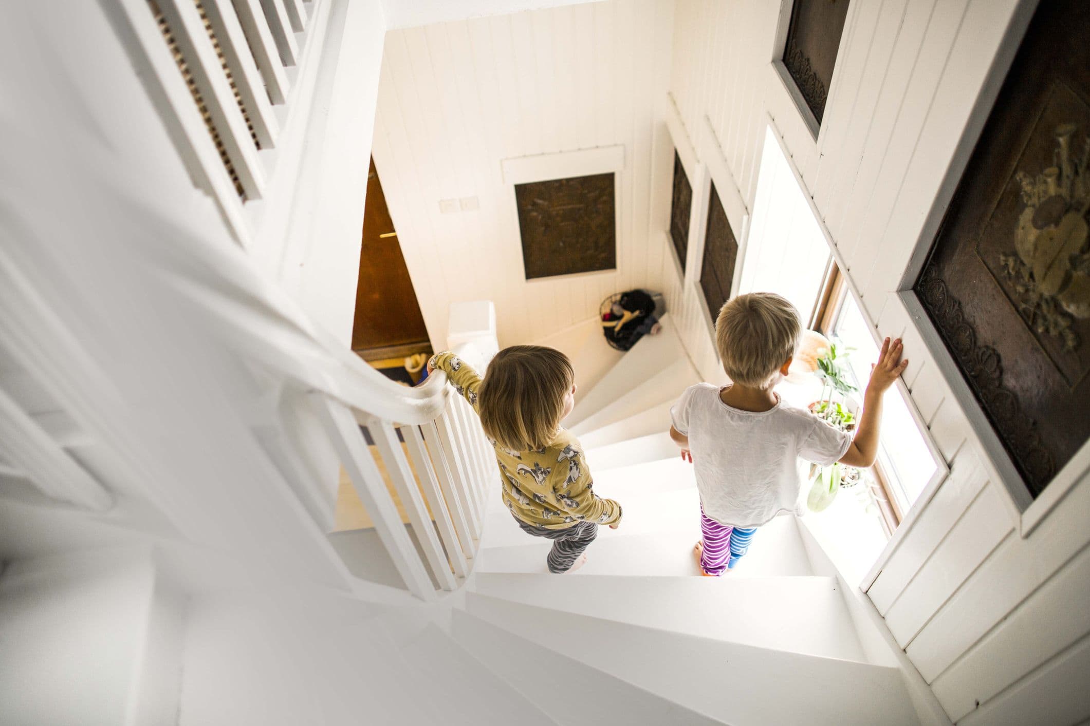 Children going downstairs on a newly painted home